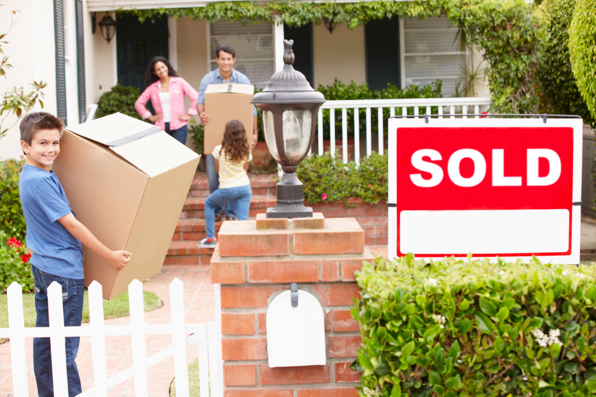 Family moving into new home with boxes